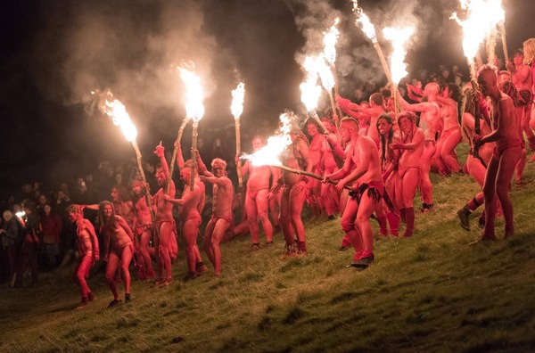 Reds and Beasties with torches running down the Hill