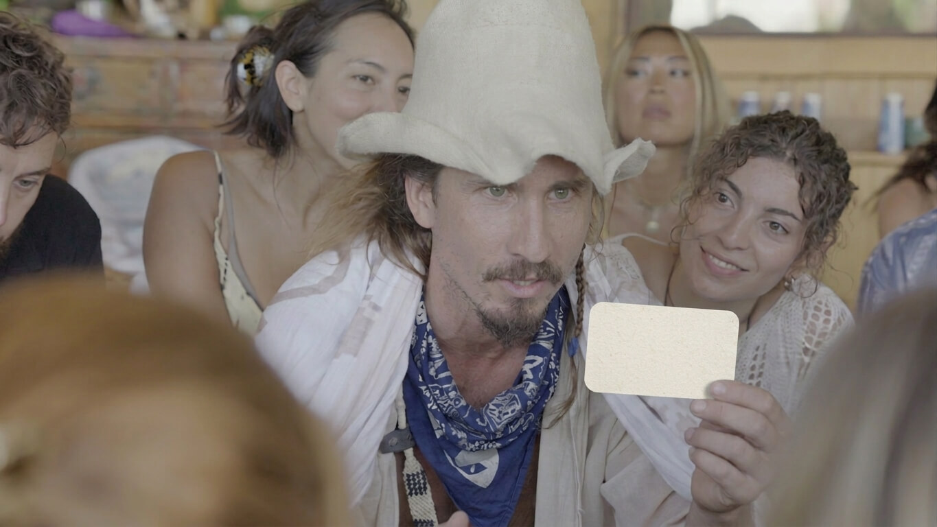Michał holding up a card with a group at the UP Game